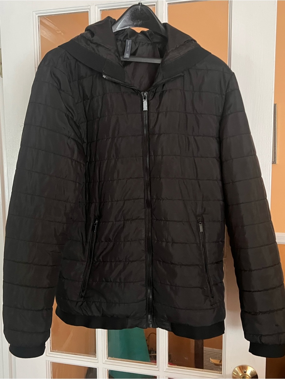 black Zara Man quilted puffer jacket with a front zipper, attached hood/pockets